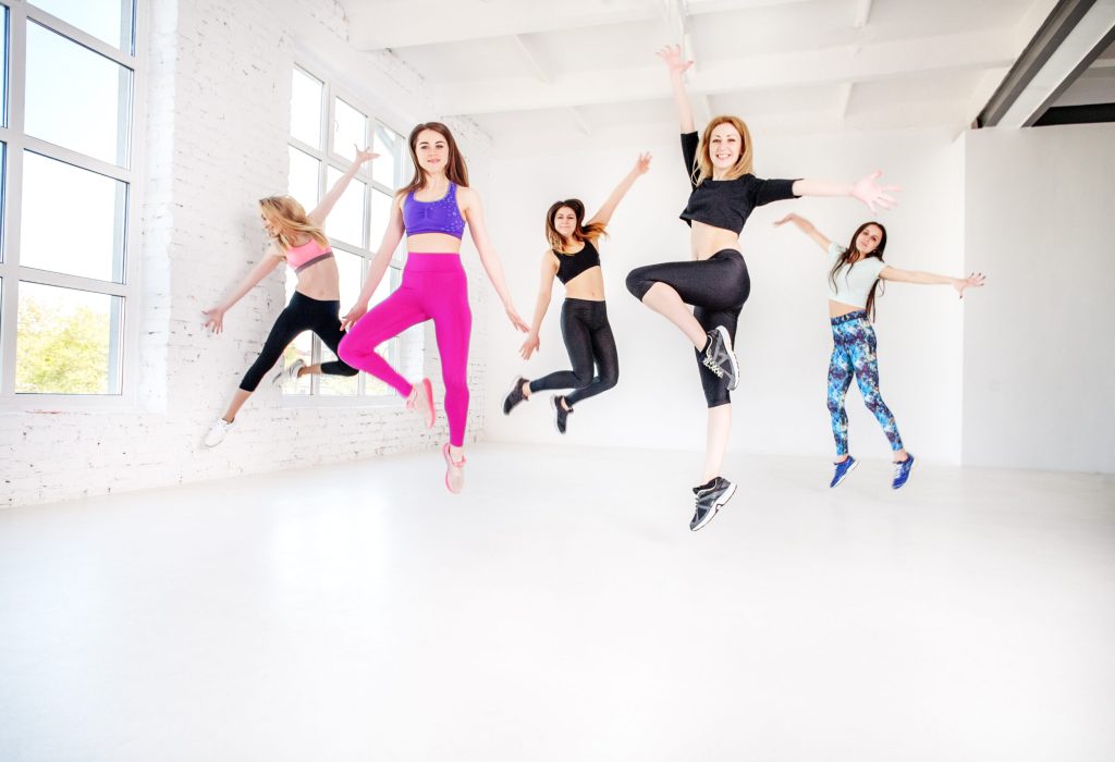 Young women dancing in the gym. Jump. The concept of sport, dance and a healthy lifestyle.